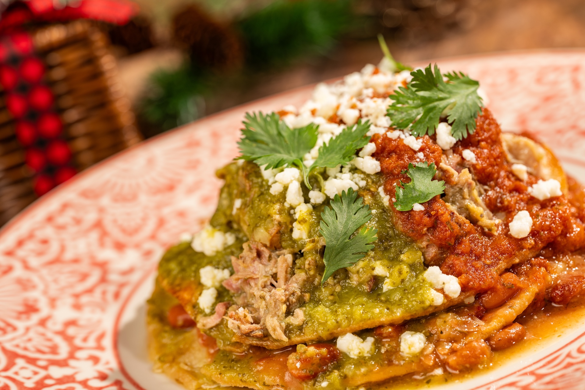 Tostada de Nochebuena with smoked pork, salsa verde, smoked tomato salsa, queso fresco, and cilantro (New) (Available during Mickey&rsquo;s Very Merry Christmas Party only) 