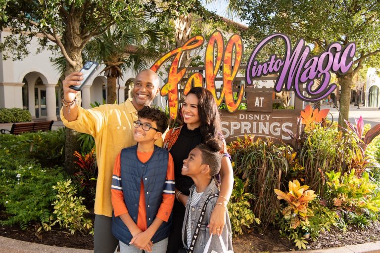 Family taking a photo at Disney Springs.