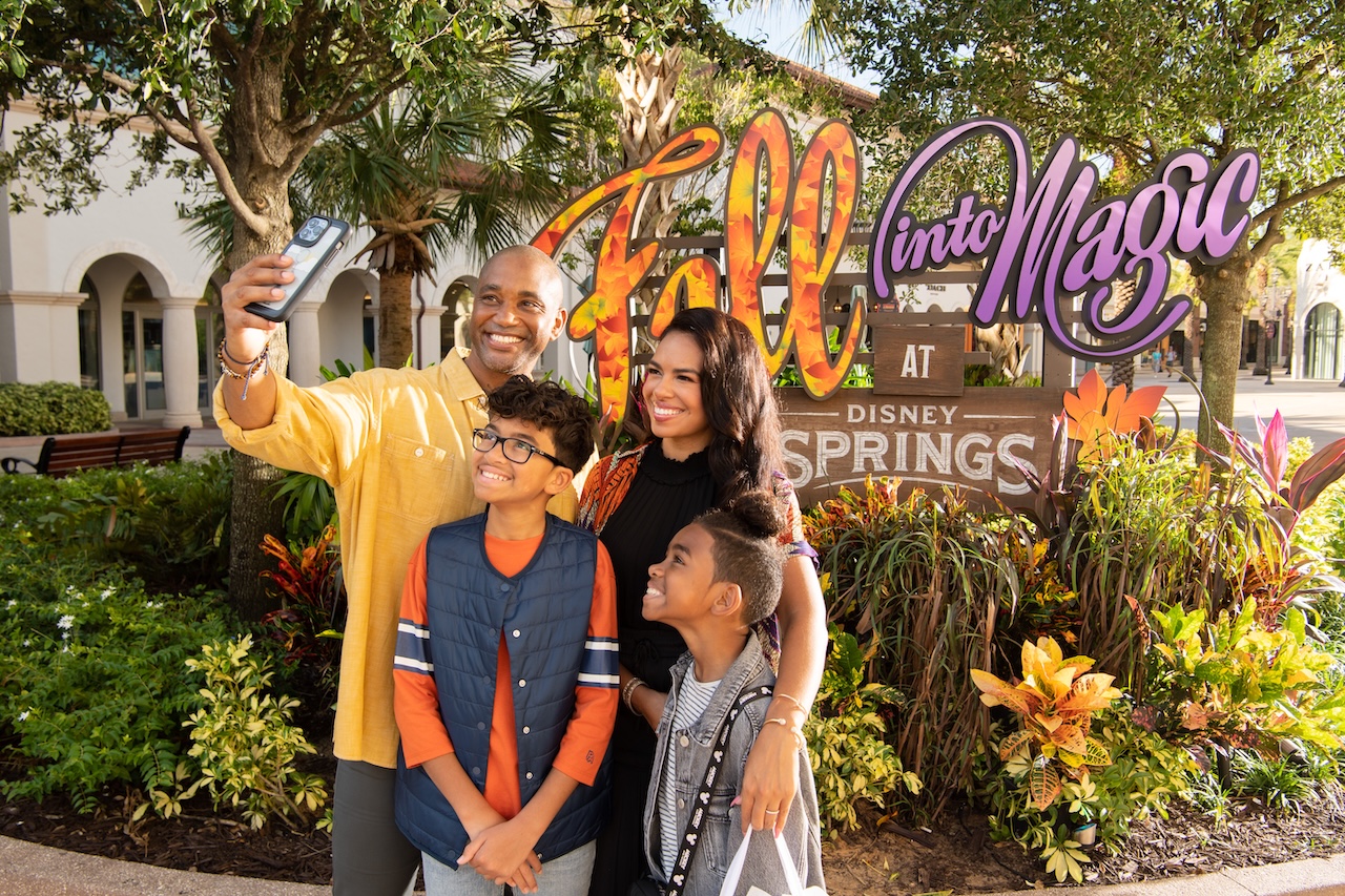 Family taking a photo at Disney Springs.